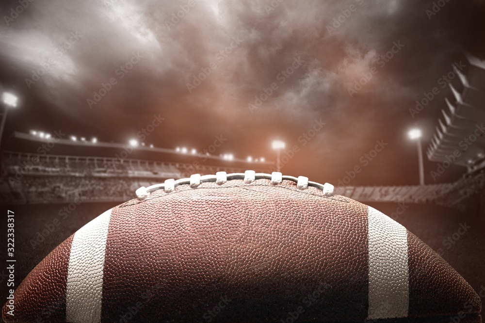 American football ball on dark background