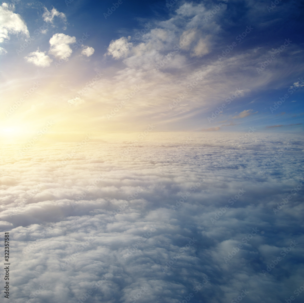 Sunrise above clouds from airplane