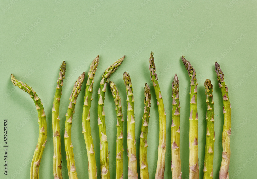 fresh asparagus on green background