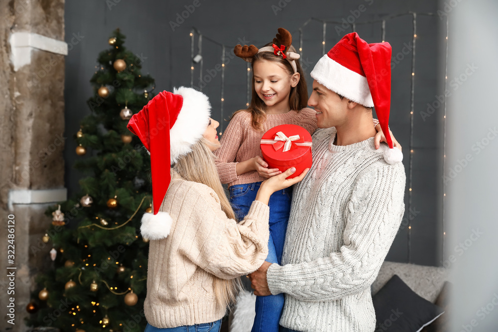 Happy family with Christmas gift at home