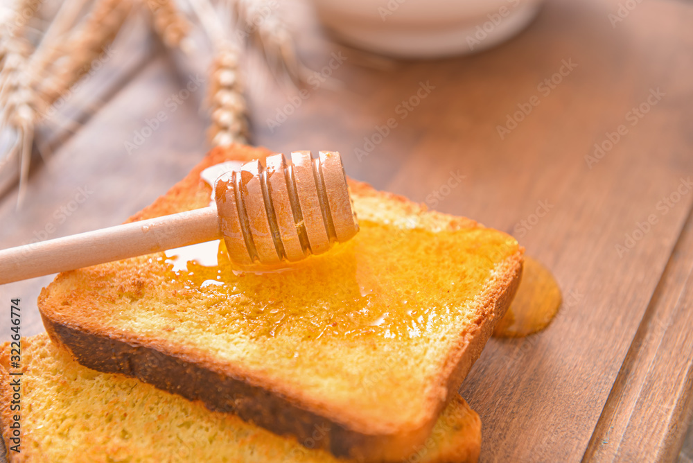 Toasted bread with honey on table