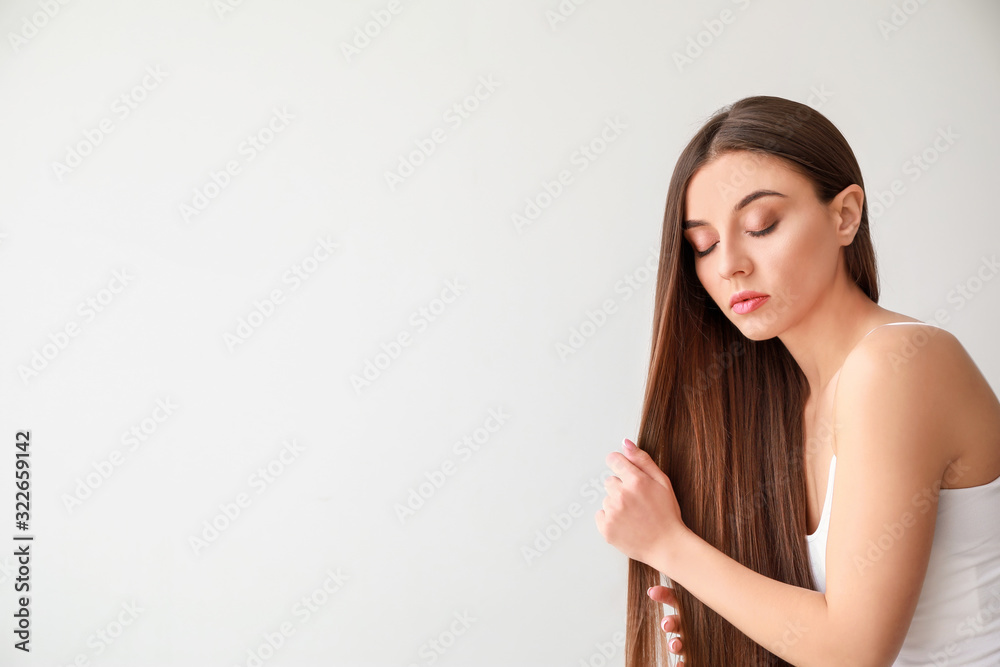 Beautiful woman with healthy long hair on white background