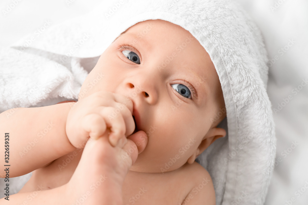 Portrait of cute little baby with towel