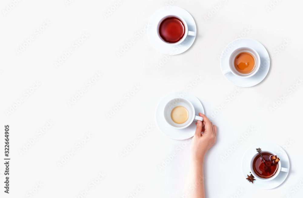 Female hand holding a tea cup overhead view - flat lay