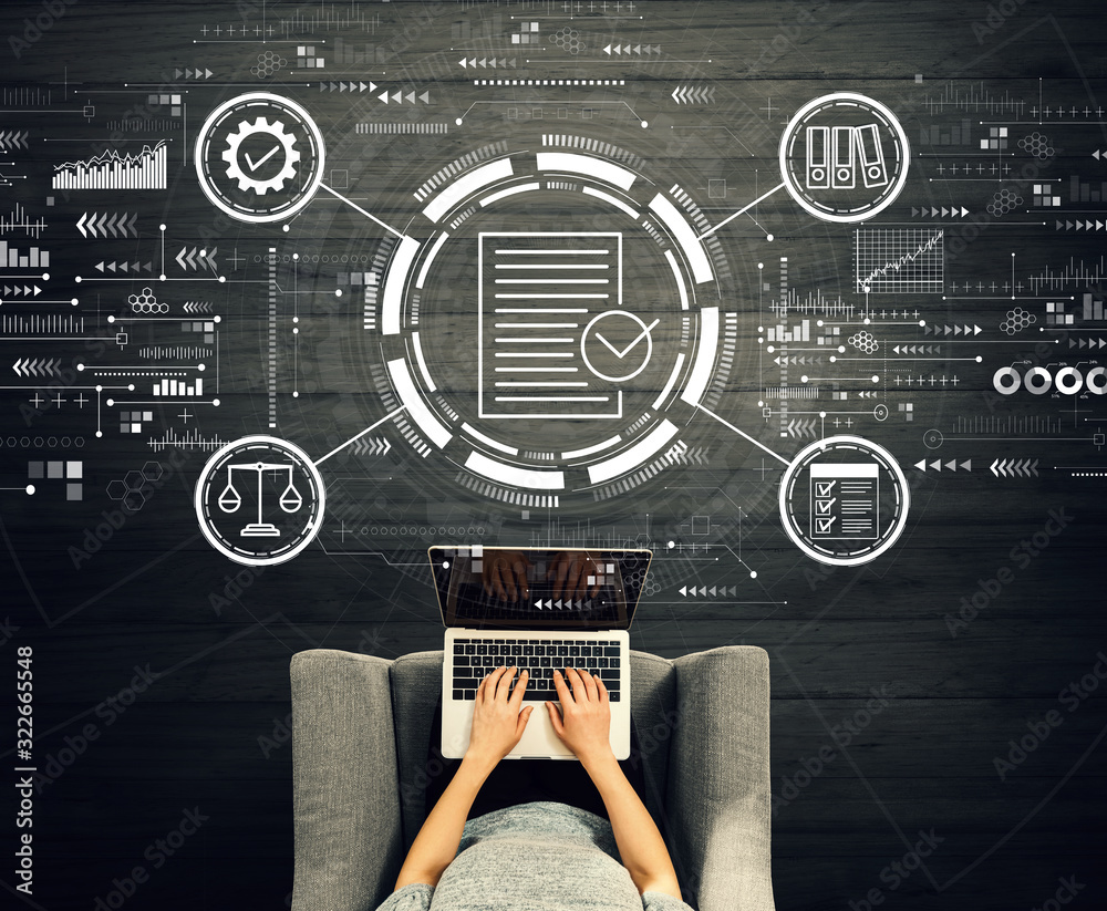 Compliance concept with person using a laptop in a chair