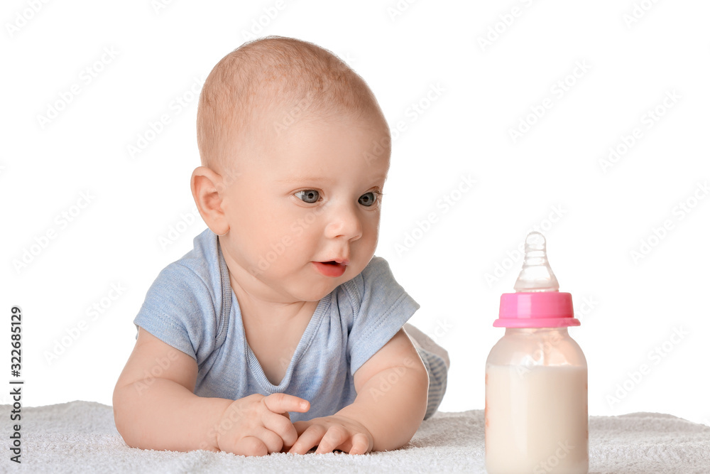 Portrait of cute little baby with bottle of milk on white background