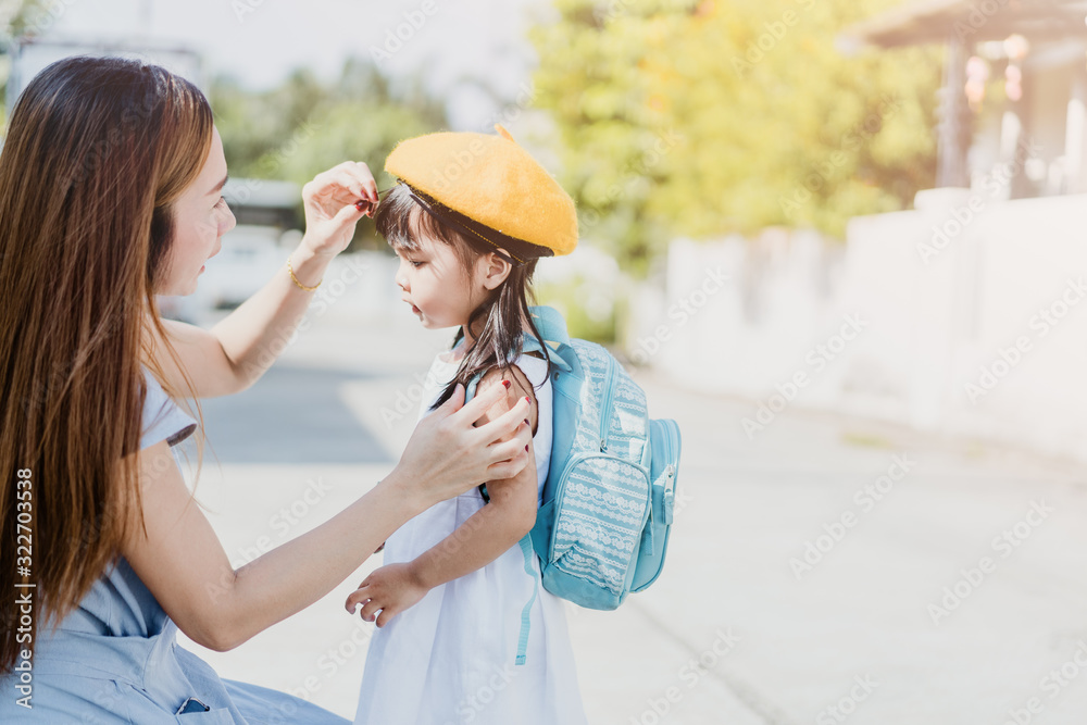 Asian thai mother and toddler child baby girl holding retro vintage photo camera in green park.Mothe