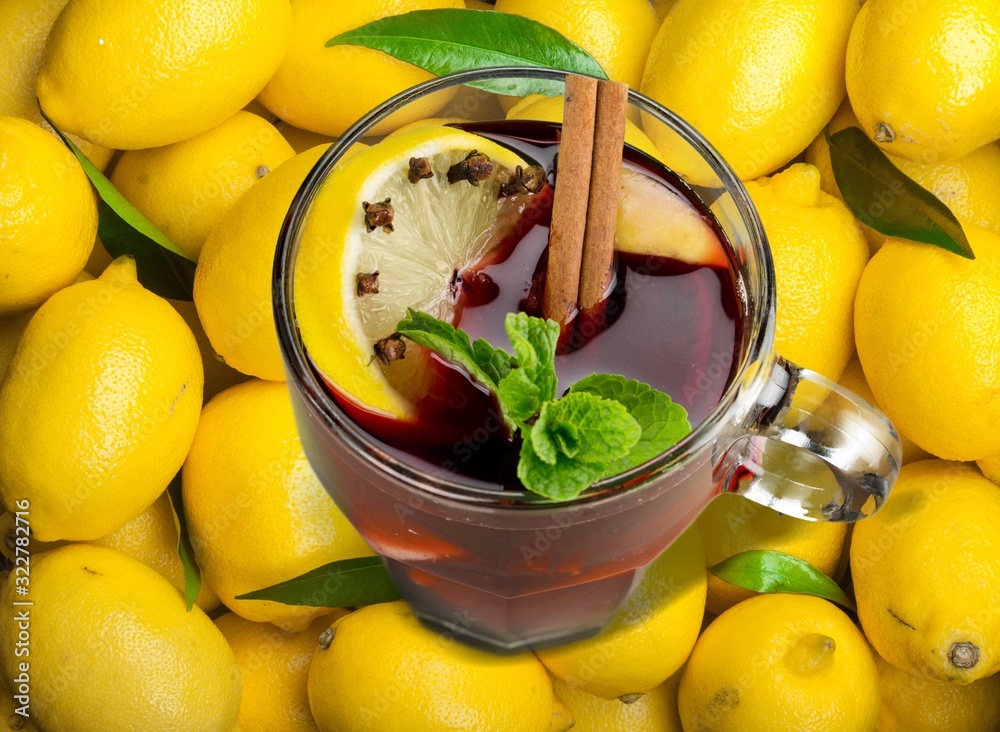 Tea in glass cup with fresh yellow lemons