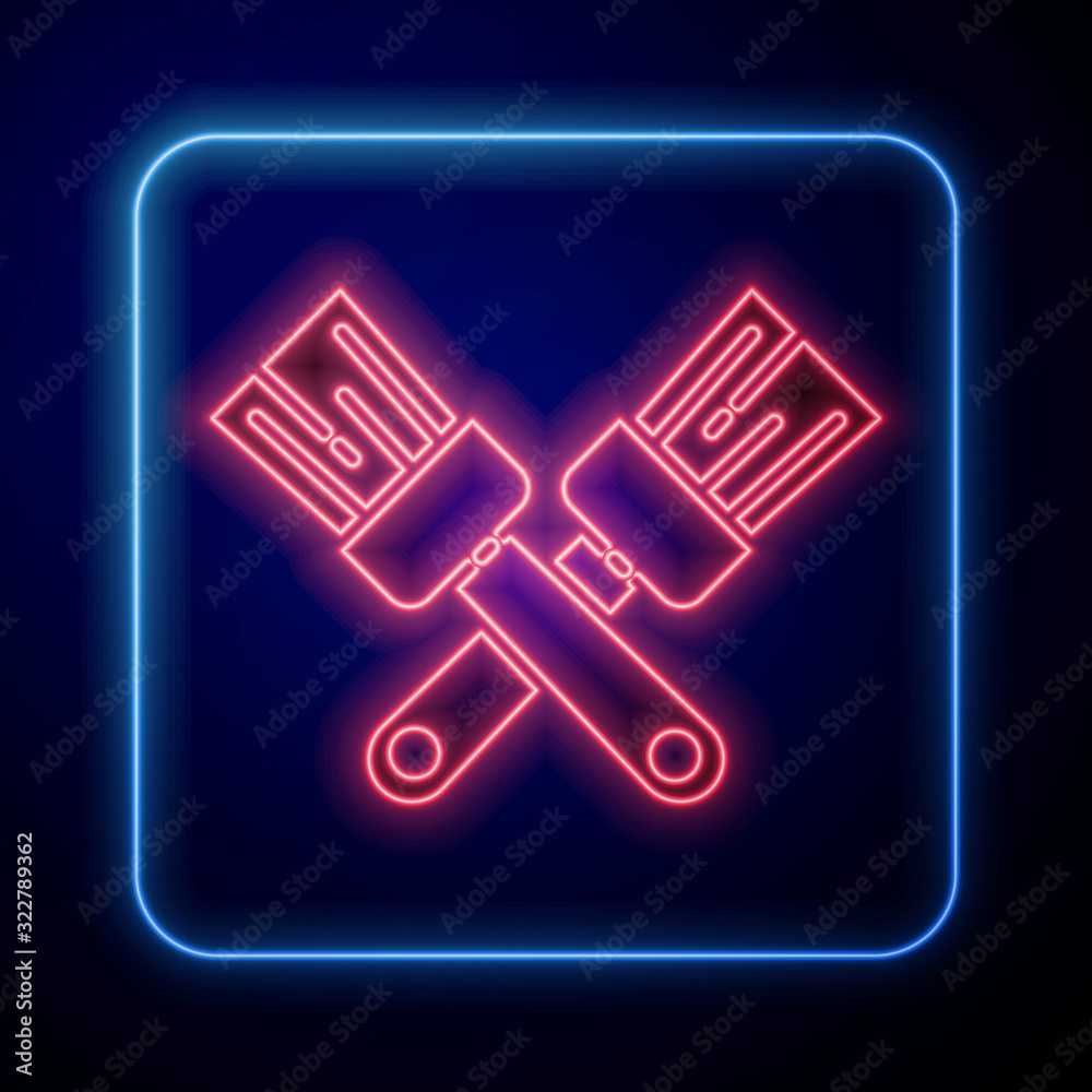 Glowing neon Crossed paint brush icon isolated on blue background.  Vector Illustration