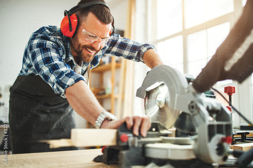 young male carpenter working in  workshop.