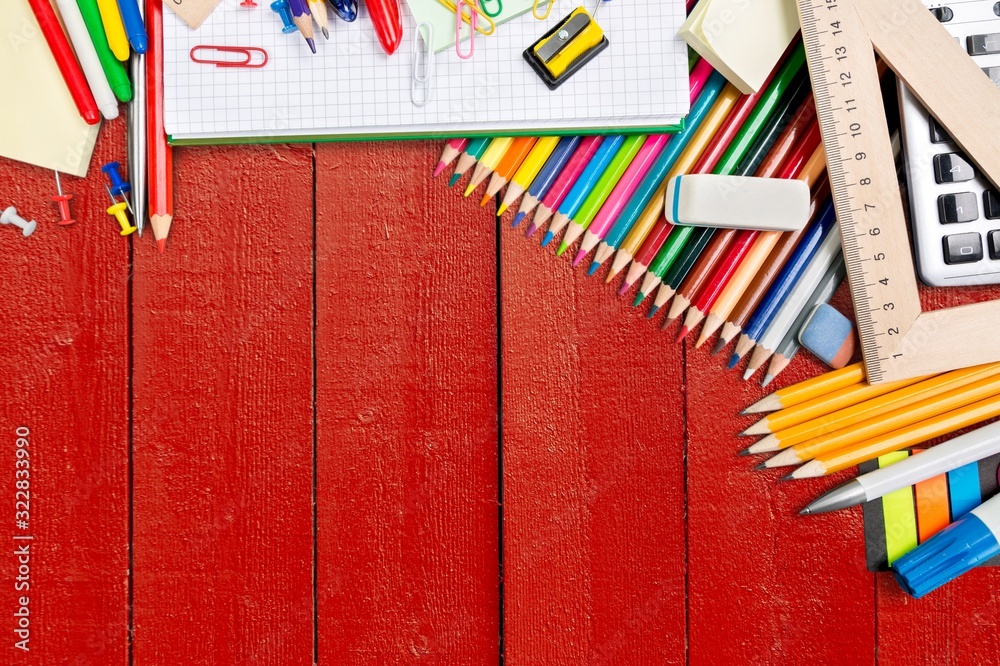 Assortment of colored school supplies on desk