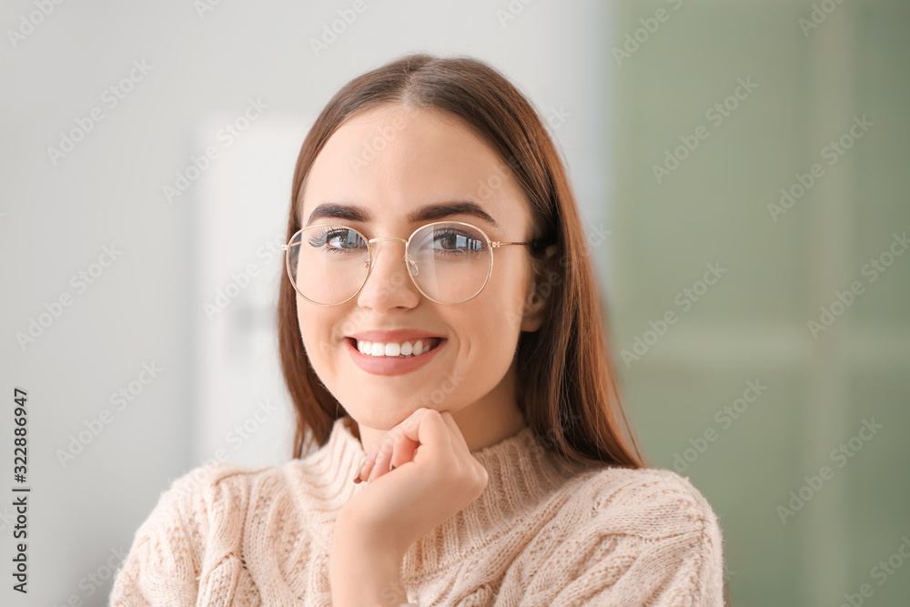 Young woman with stylish eyeglasses at home