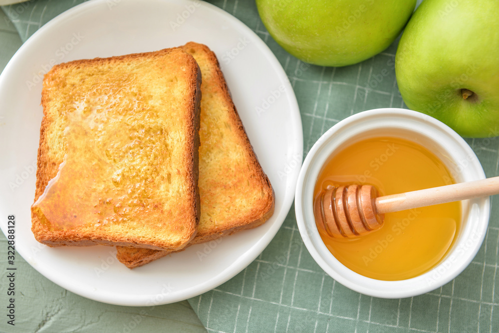 Sweet honey, apples and toasted bread on table