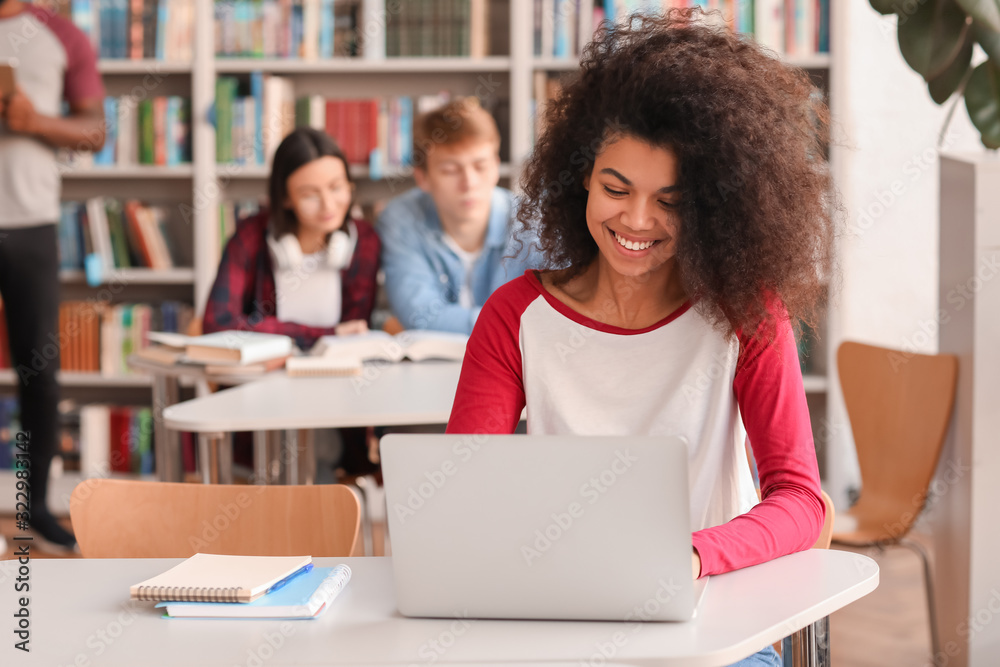 African-American student preparing for exam in library