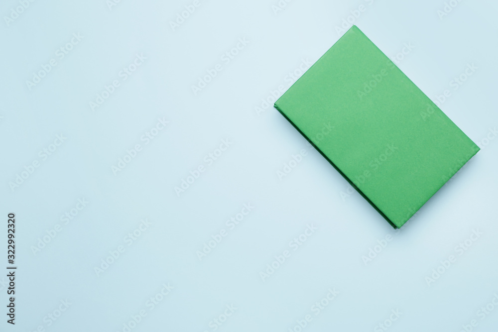 Book with blank cover on color background