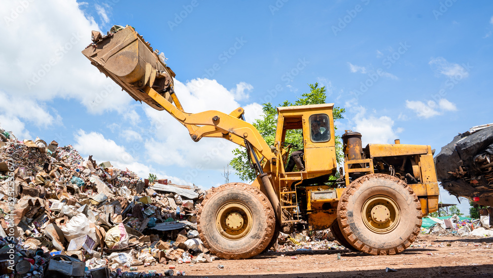 Construction worker,Engineer working on junkyard at waste recycling plant,Copy space available.