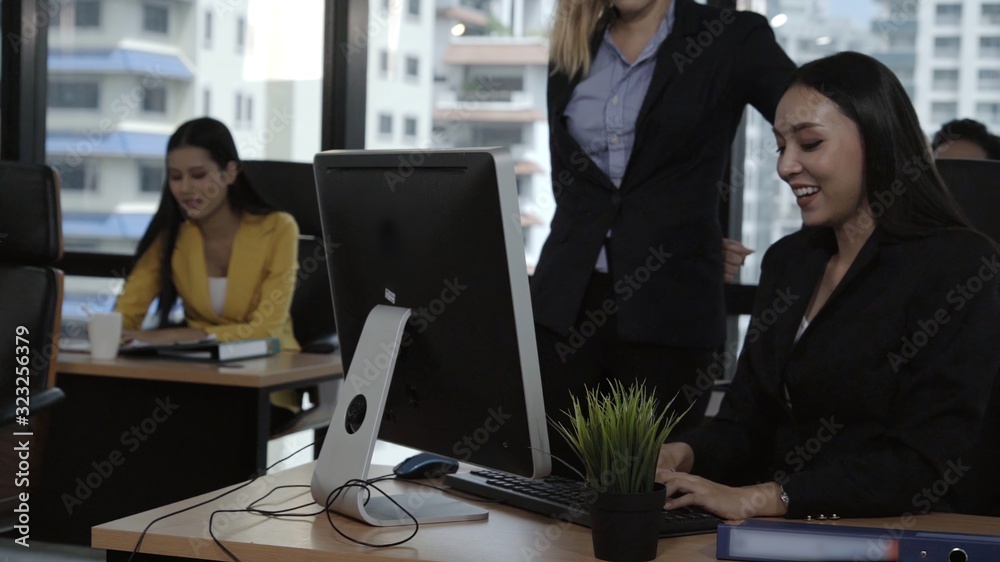 Young leader gives advice to young woman worker in modern office. Leadership and training concept.