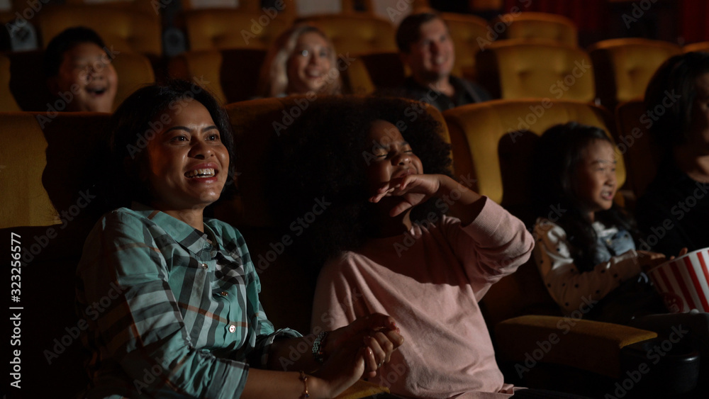 People audience watching movie in the movie theater cinema. Group recreation activity and entertainm