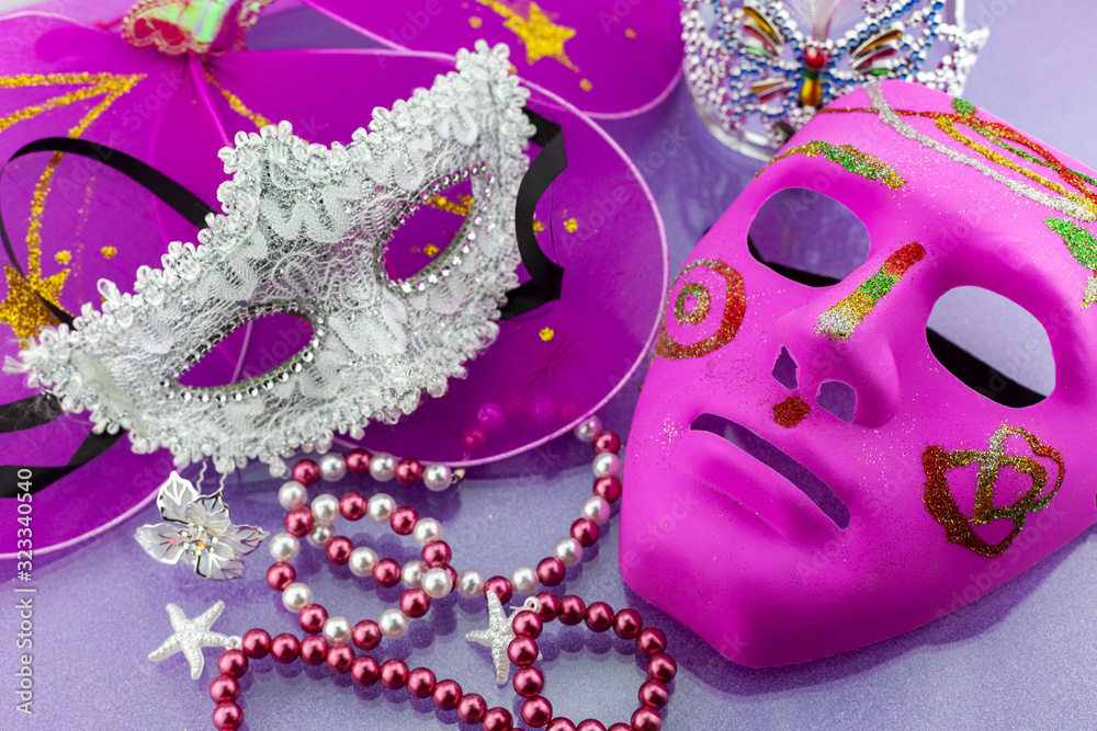 A festive,Beautiful mardi gras or carnival mask on beautiful colorful paper background.