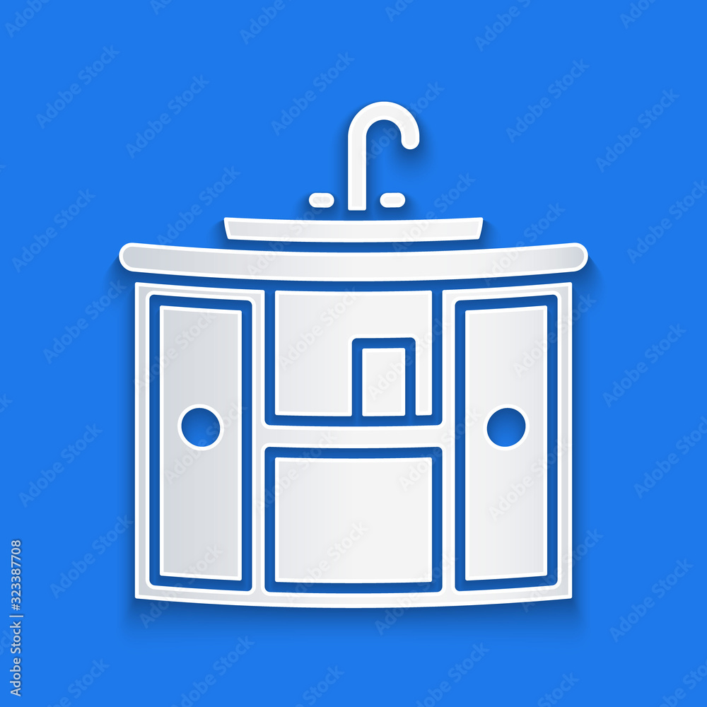 Paper cut Washbasin cabinet with water tap icon isolated on blue background. Paper art style. Vector