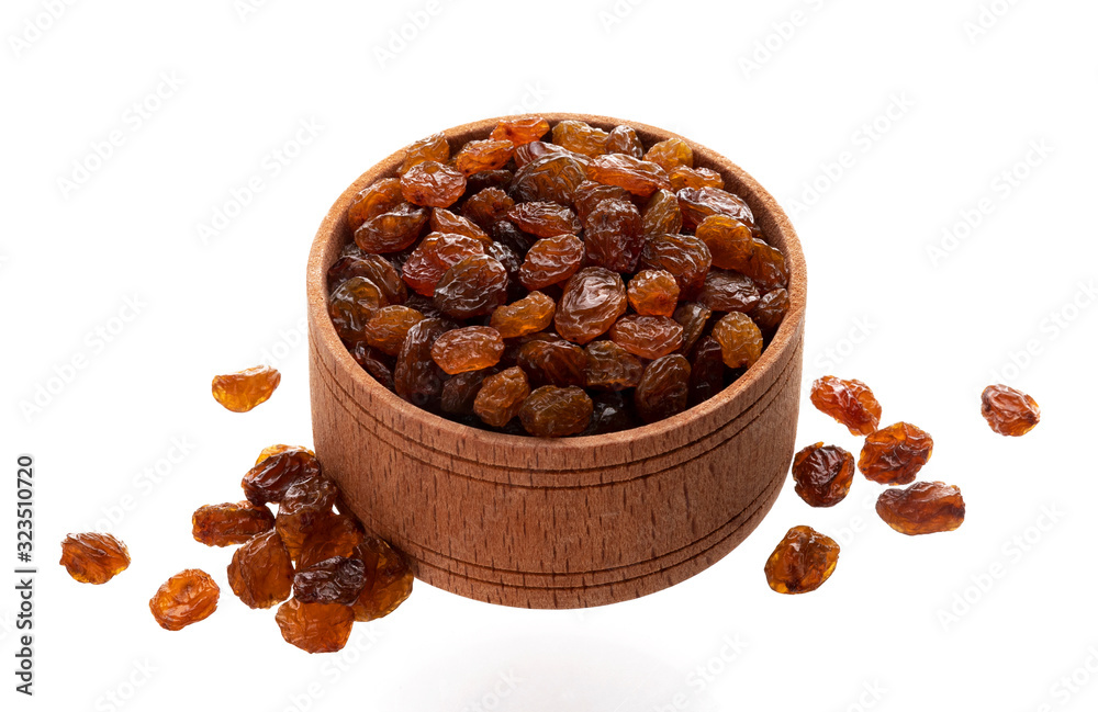 Raisins in wooden bowl isolated on white background