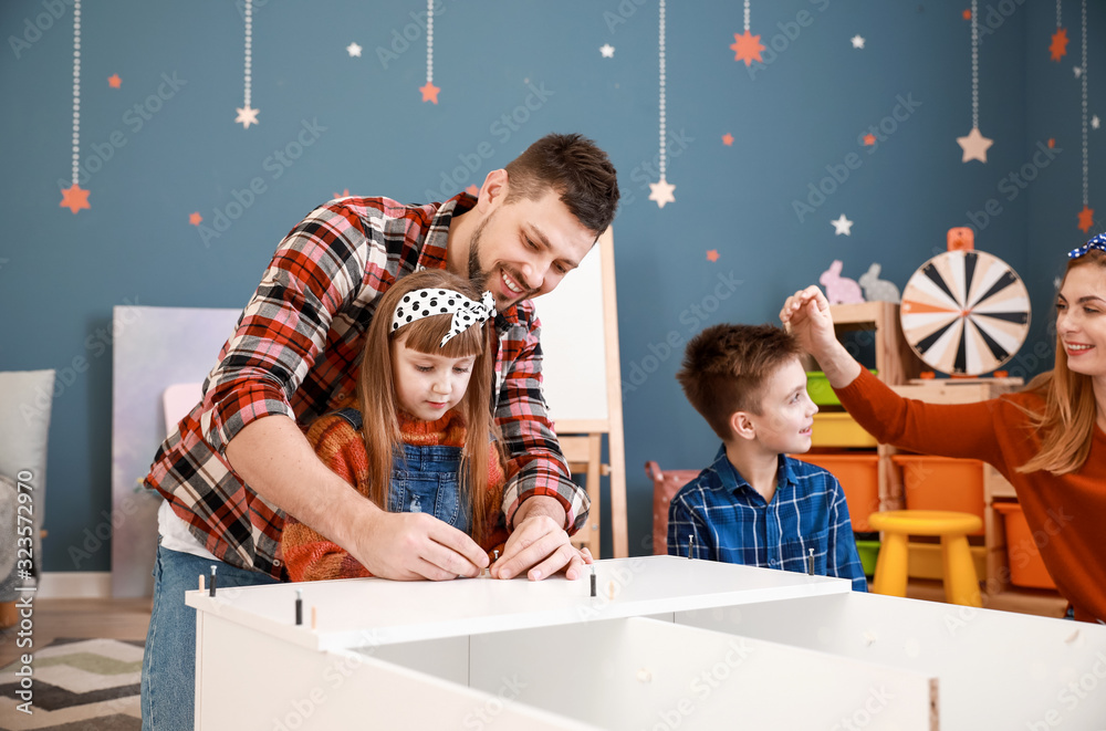 Family assembling furniture at home