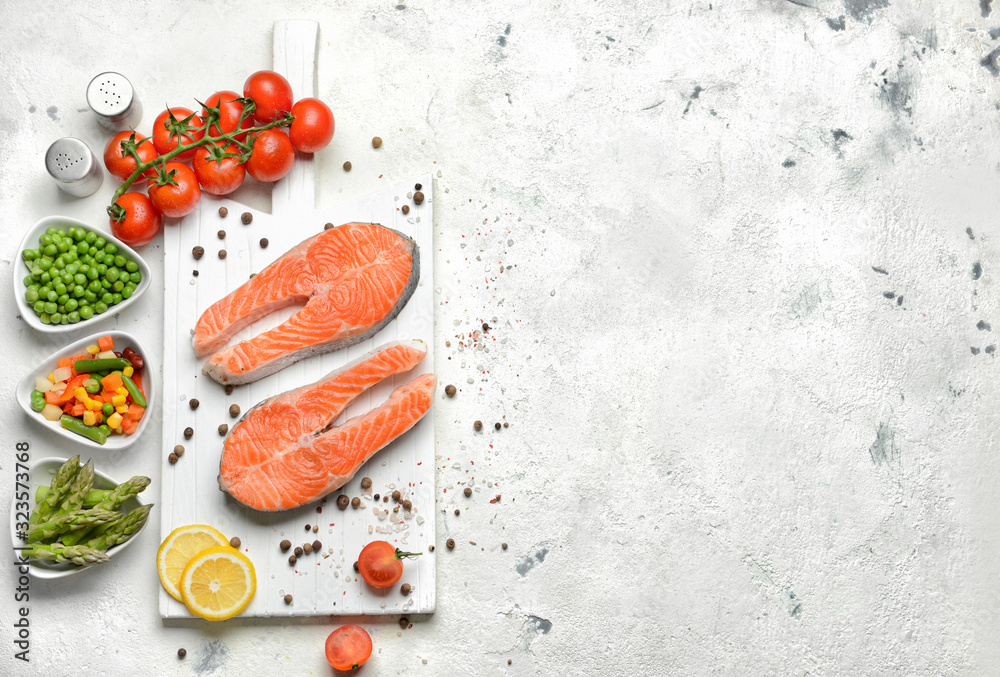 Composition with raw salmon steaks on table