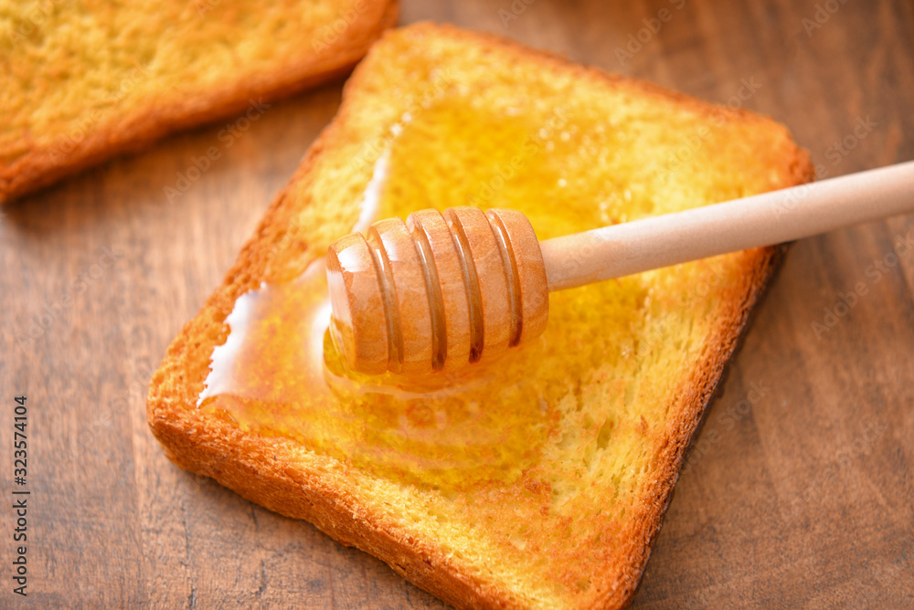 Toasted bread with honey on table