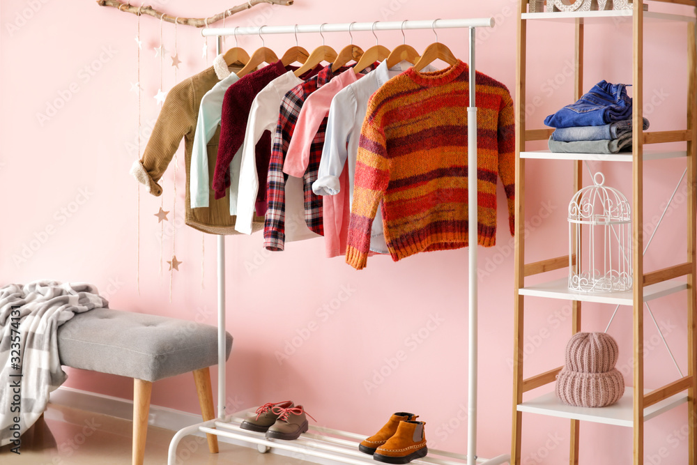 Interior of modern dressing room with winter clothes