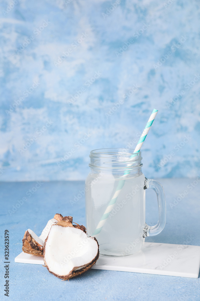 Mason jar of fresh coconut water on table