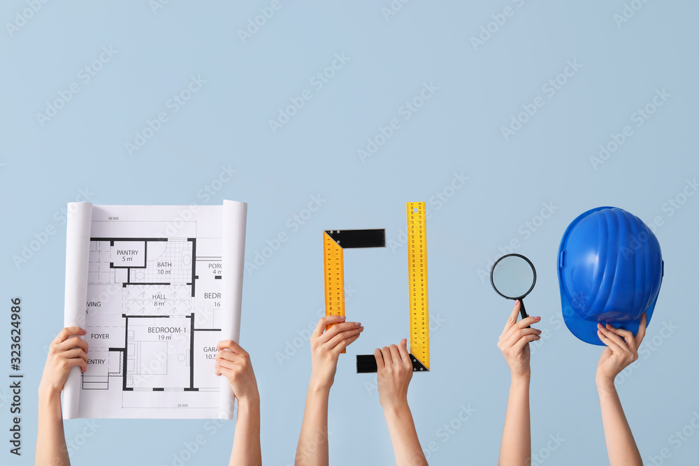 Many hands with architects supplies on color background