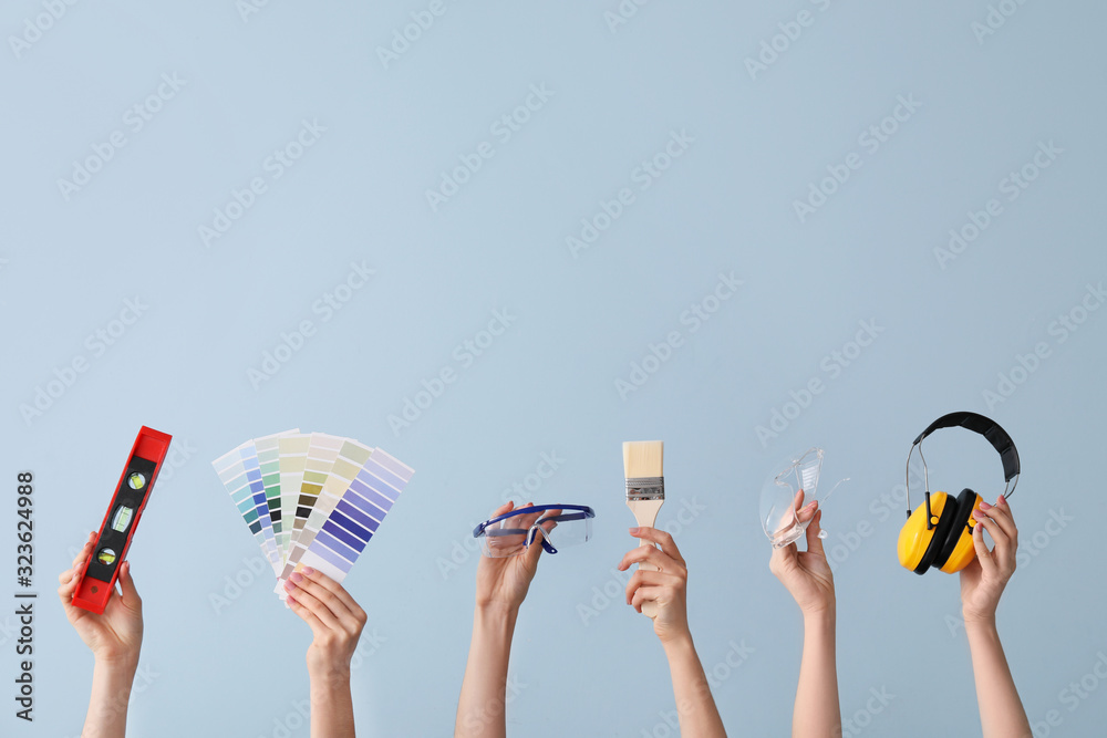 Many hands with architects supplies on color background