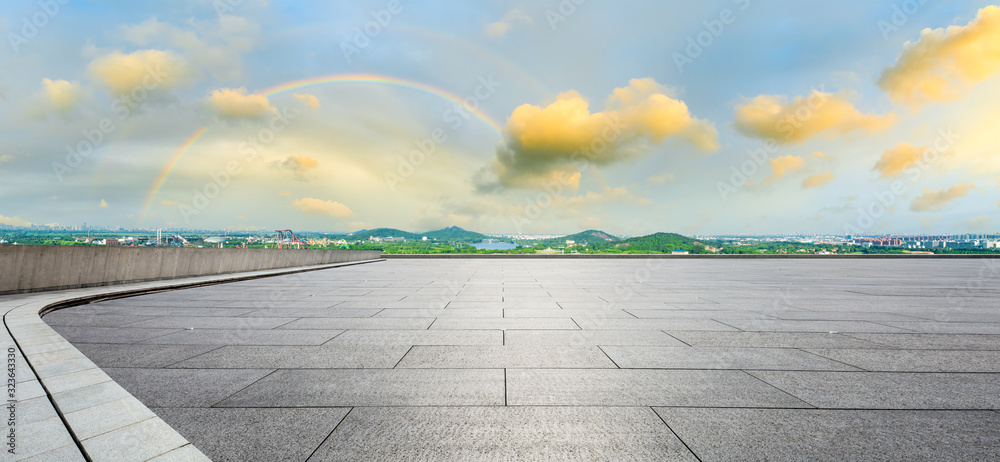 Wide square floor and city suburb skyline at sunset in Shanghai,panoramic view.