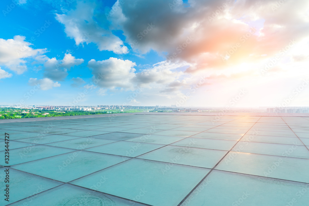 Glass square floor and city suburb skyline at sunset in Shanghai.