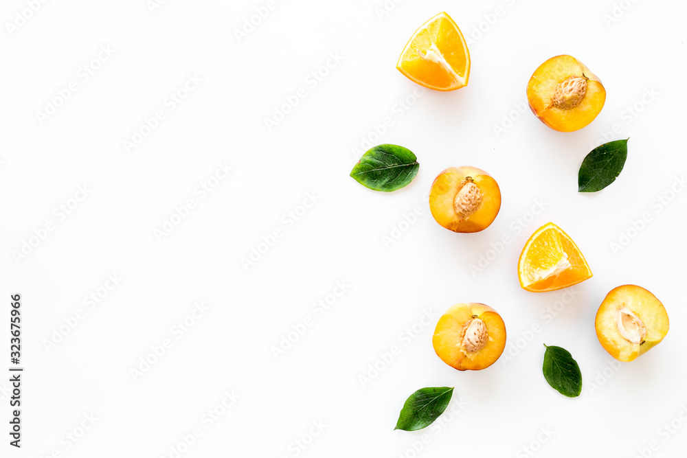 Peach slices and leaves pattern on white background top-down frame copy space