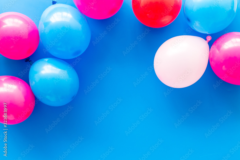 Decorative frame with colorful balloons on blue background top-down frame copy space