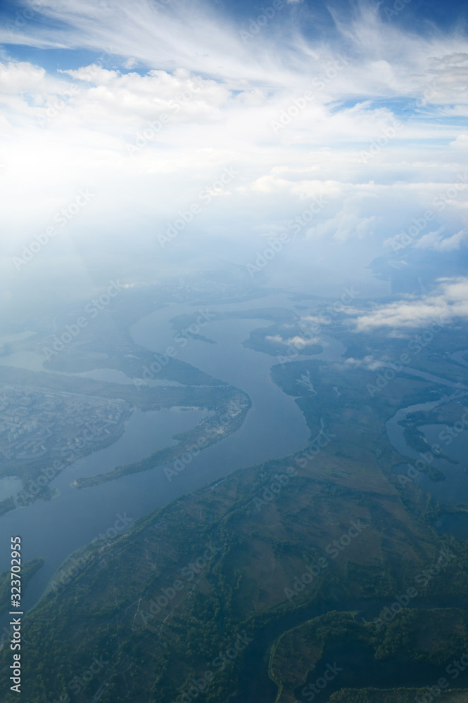 Aerial view of a green landscape with a river