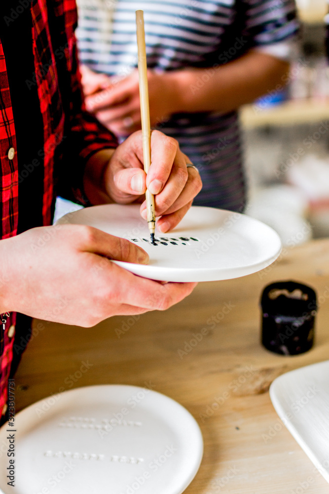 workshop production of ceramic tableware product painting