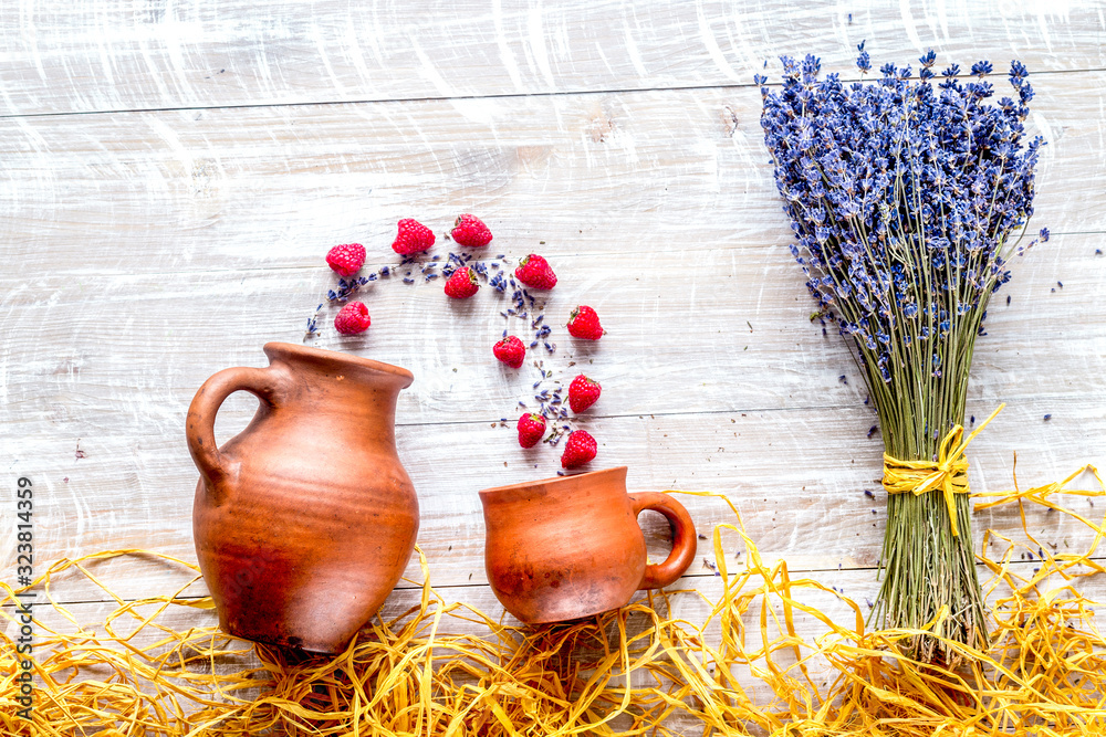 laveder composition with jar, cup, raspberry on rustic background top view mock-up