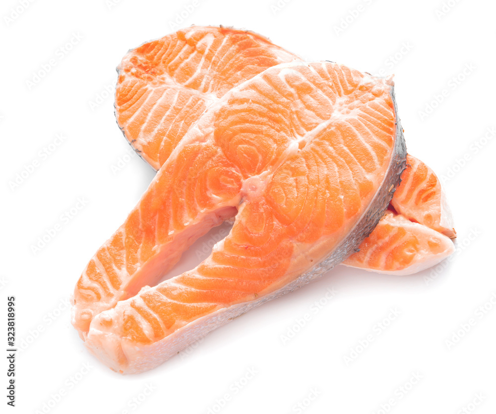 Raw salmon steaks on white background