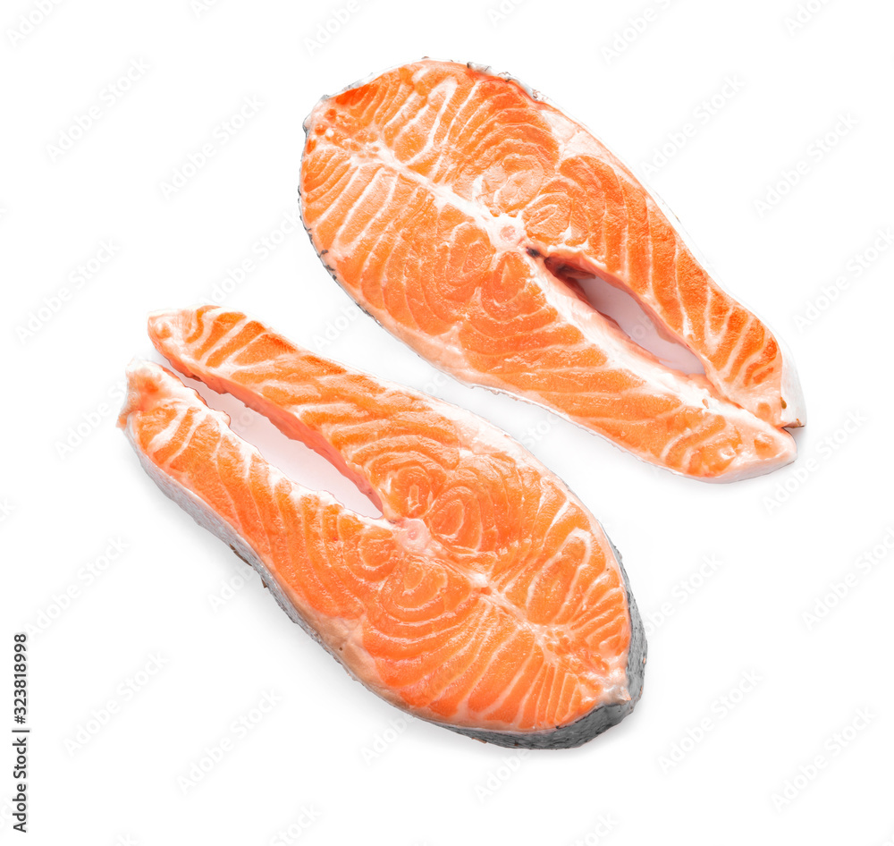 Raw salmon steaks on white background