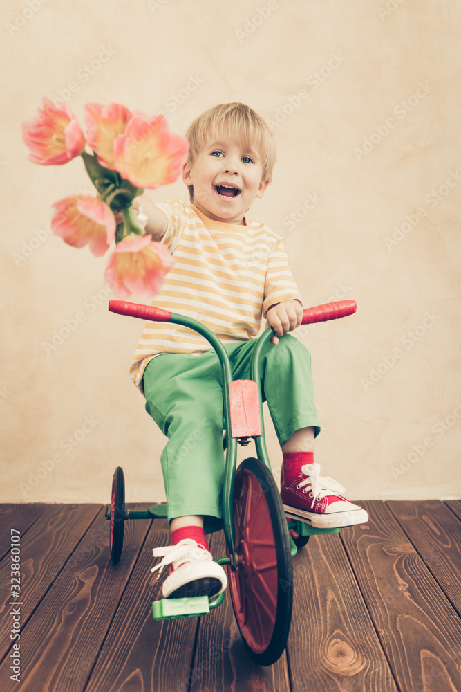 Funny child holding bouquet of flowers