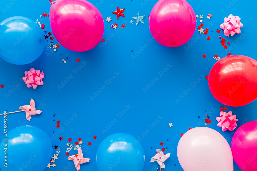 Party concept. Colorful balloons and confetti on blue background top-down frame copy space