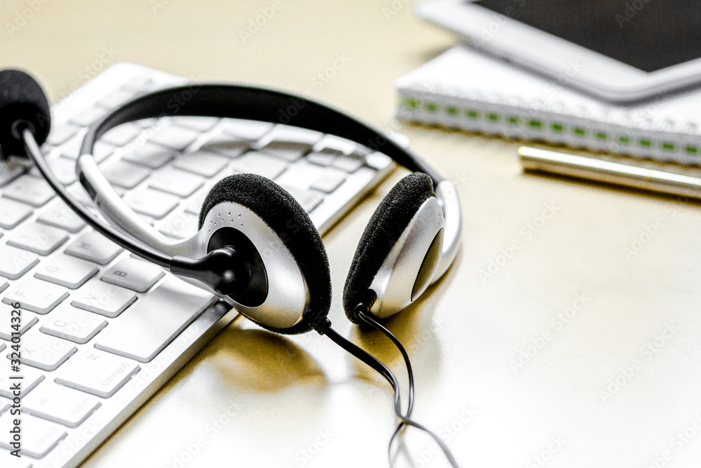 headset and keyboard on workdesk for call center concept