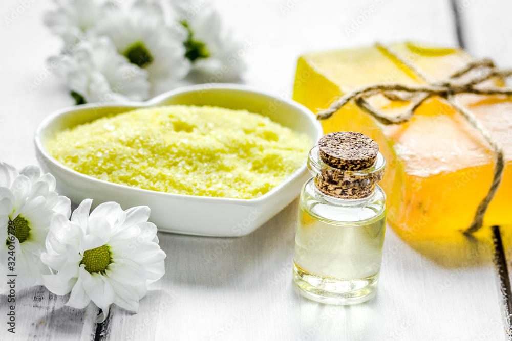 organic cosmetics with camomile extract on wooden table background