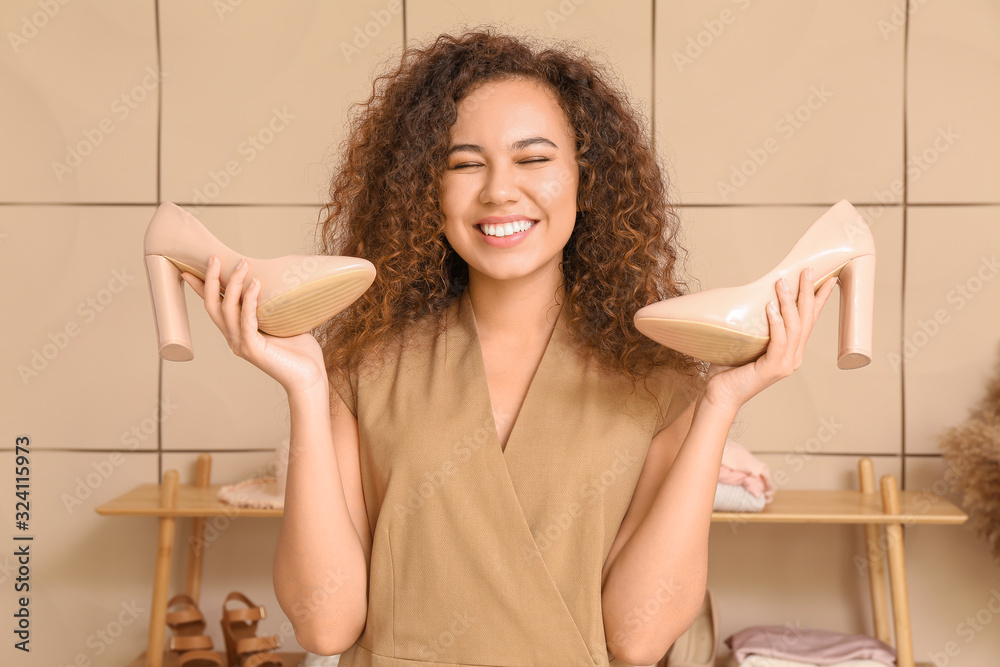 Beautiful African-American stylist at workplace