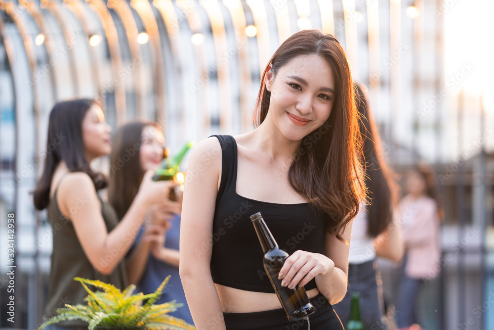 Portrait young cute Asian girls gang best friends having party at rooftop restaurant. Girls drinking