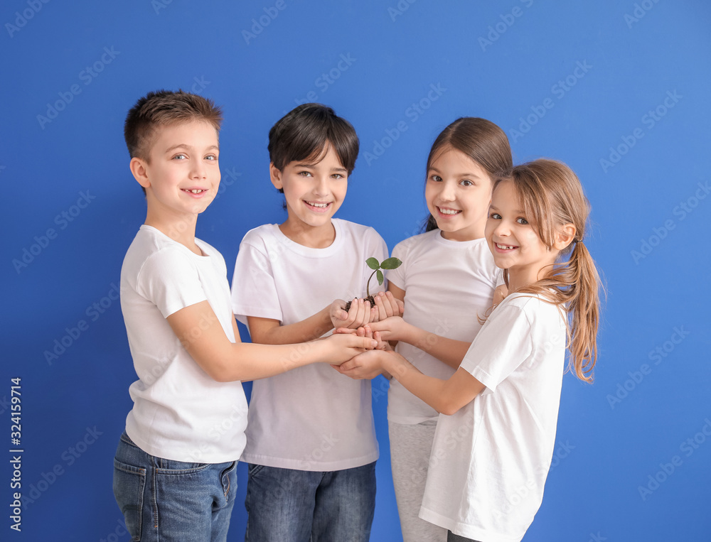 Little children with plant and soil on color background. Earth Day celebration