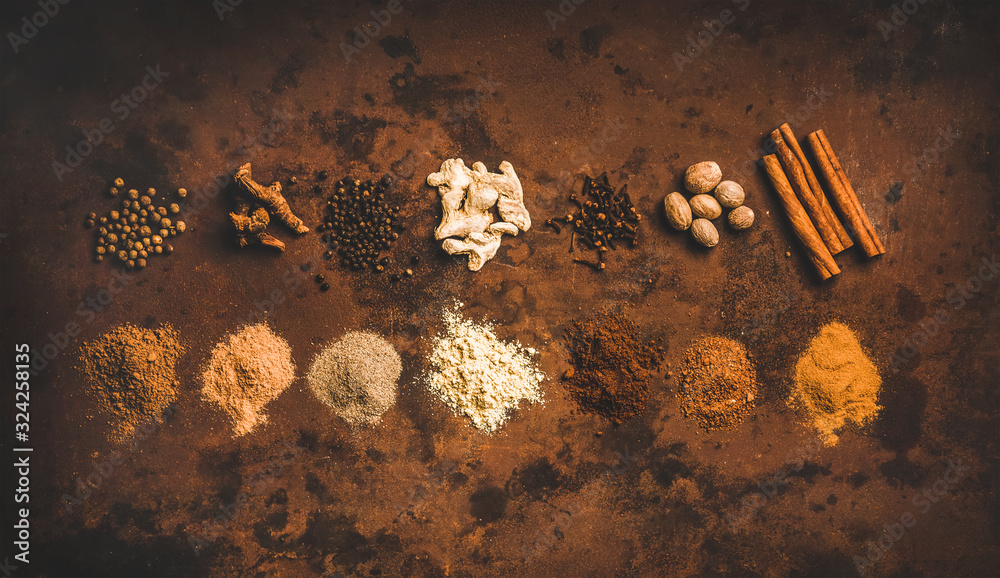 Turkish seven spice Yedi Bahar mix. Flat-lay of black pepper, ginger, cloves, nutmeg, cinnamon, alls