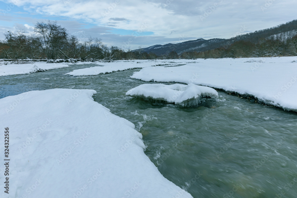 River passing through a mountain gorge in winter